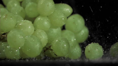 green grapes in super slow motion receiving drops