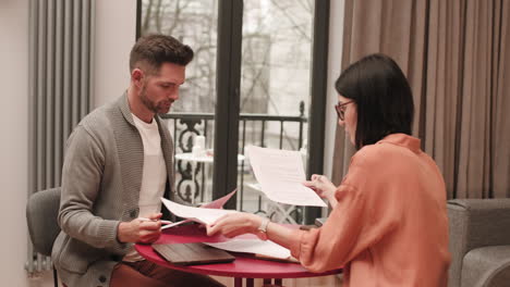 caucasian man and woman sorting papers