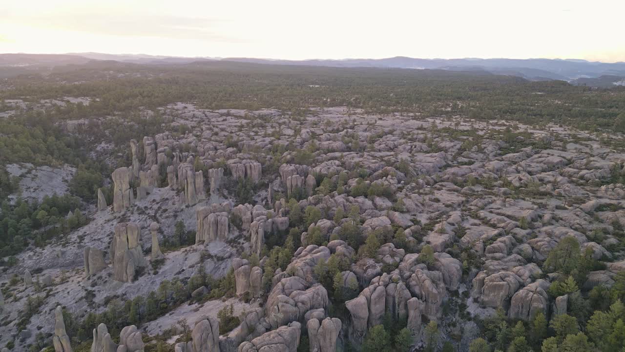 Rock pillars in Valle de los Monjes, forested plateau at sunset in Creel, Mexico
