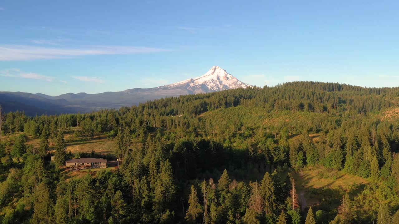 Slow flight towards the snowy peak of Mt. Hood looking over the Oregon mountains