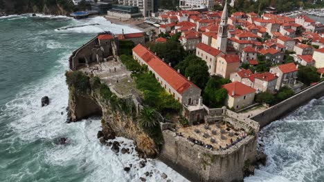 old town of budva in montenegro by coast of adriatic sea, aerial parallax