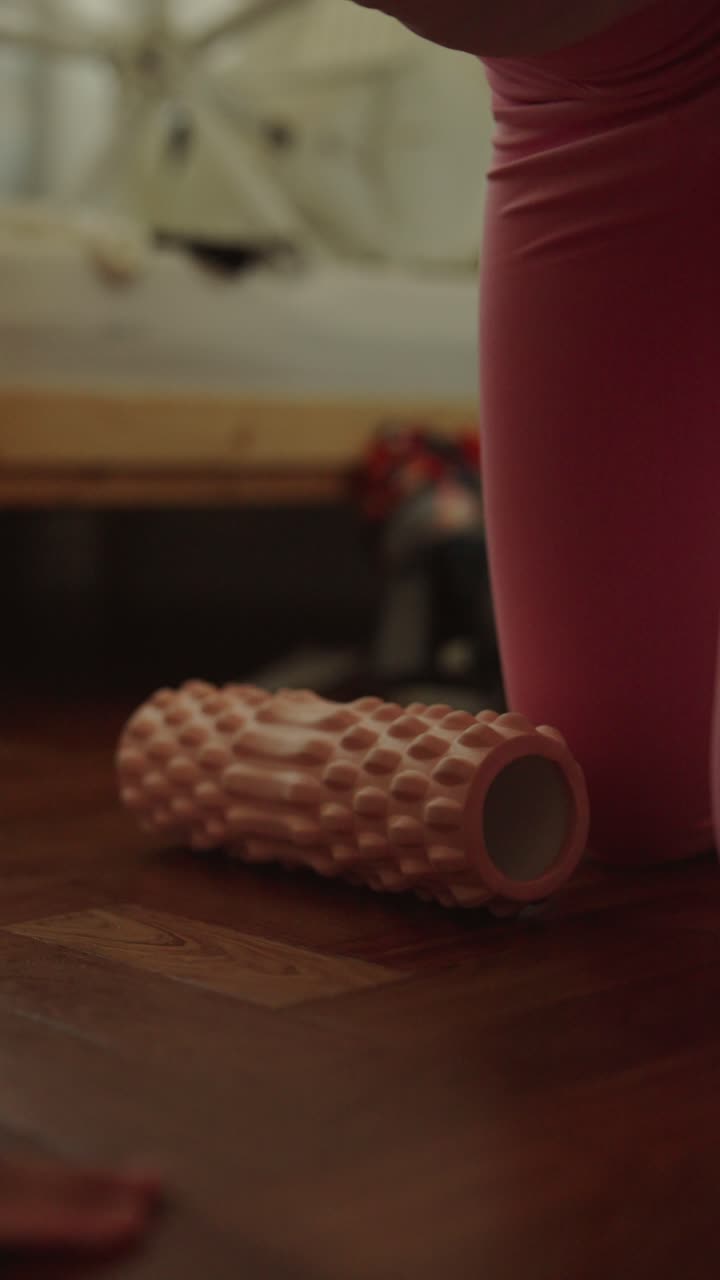 mujer usando un rodillo de espuma para el estiramiento de las piernas