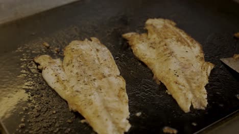 Close-Up-Shot-Of-Fish-Fillet-Grilled-On-Grill-In-Restaurant's-Kitchen