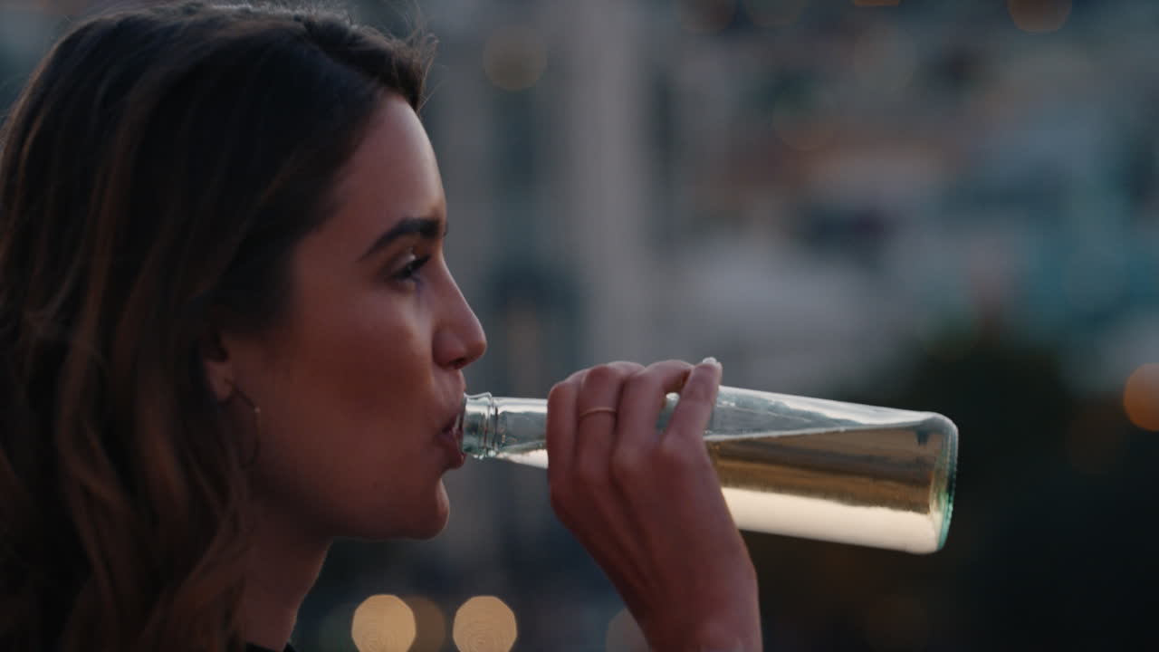 portrait beautiful young woman drinking alcohol enjoying rooftop view of city skyline at sunset smiling happy on weekend
