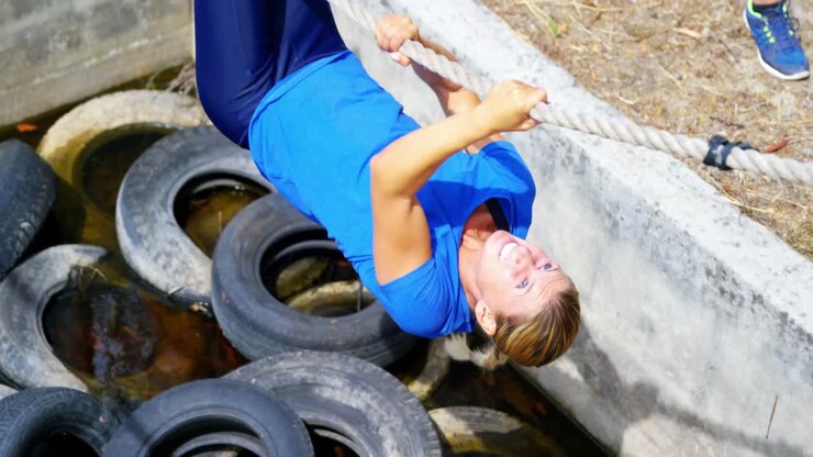 Woman crossing the rope during obstacle course 4k