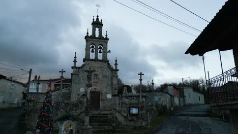 Drone-rises-past-old-buildings-to-eerie-creepy-bell-tower-church-entrance