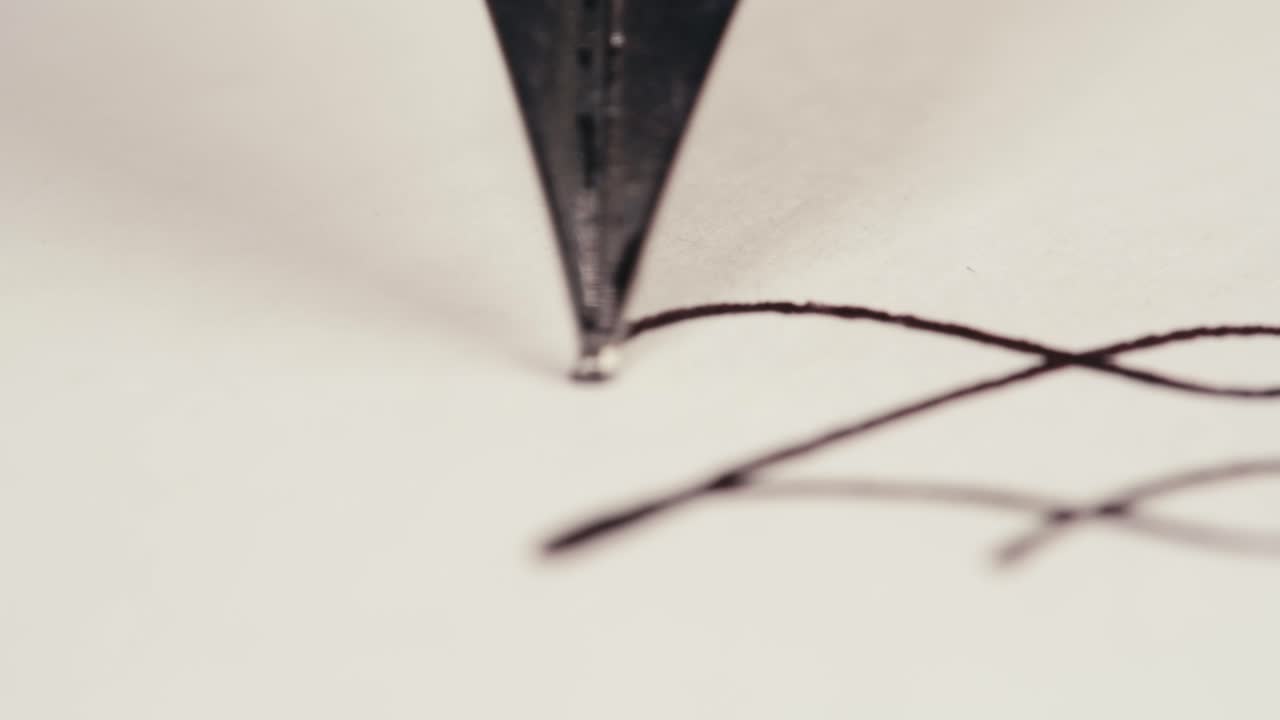 Elegant Fountain Pen Nib Writing with Ink on White Paper