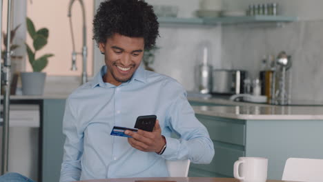 happy man using smartphone shopping online spending money on credit card mobile banking app with digital currency enjoying financial freedom