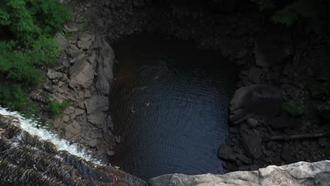 aerial view of young woman walking on top of ozone fall, tennessee state natural area