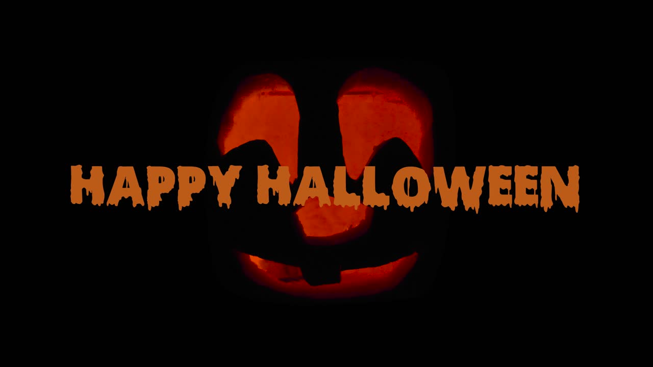 feliz halloween lindo jack o 'lantern brillando en la oscuridad con textanimation deseando feliz halloween: decoración de calabaza tallada con vela encendida en el interior
