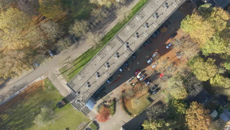 Top-down-aerial-of-flat-rooftops-and-parking-lots