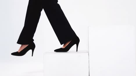 low section of businesswoman walking on steps