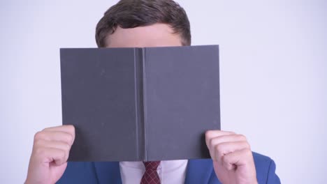 young handsome businessman with book and eyeglasses