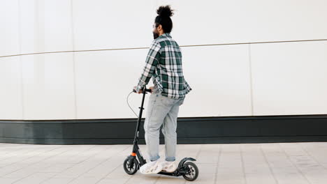 man riding an electric scooter in the city