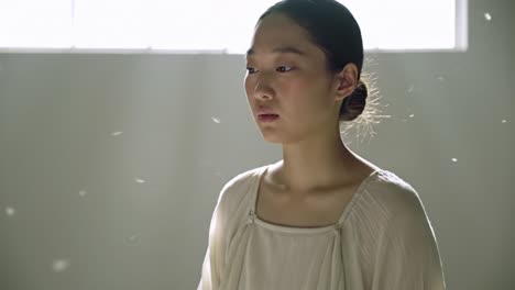 a serene moment of reflection: capturing the essence of contemplation and stillness in a softly lit space with floating particles around the subject