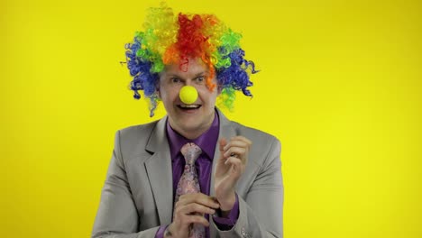 Clown-businessman-entrepreneur-boss-in-wig-shows-tricks-with-money-banknotes