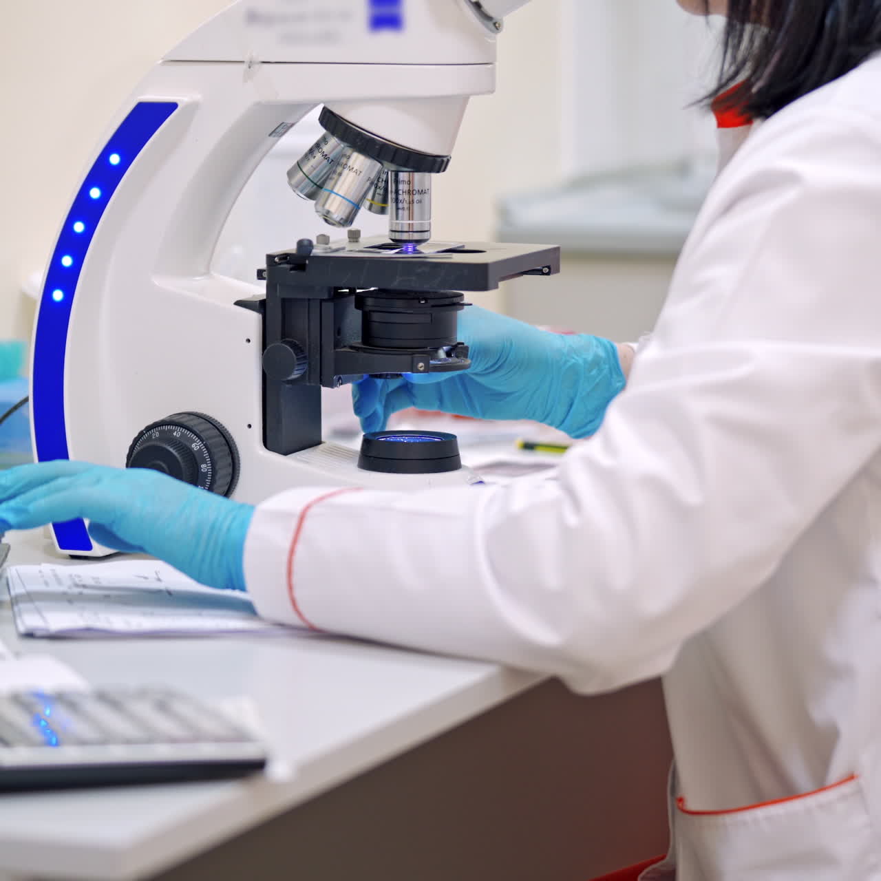 Female researcher works with contemporary microscope. Medical scientist looking through the microscope. Concept of science, testing development and lab industry.