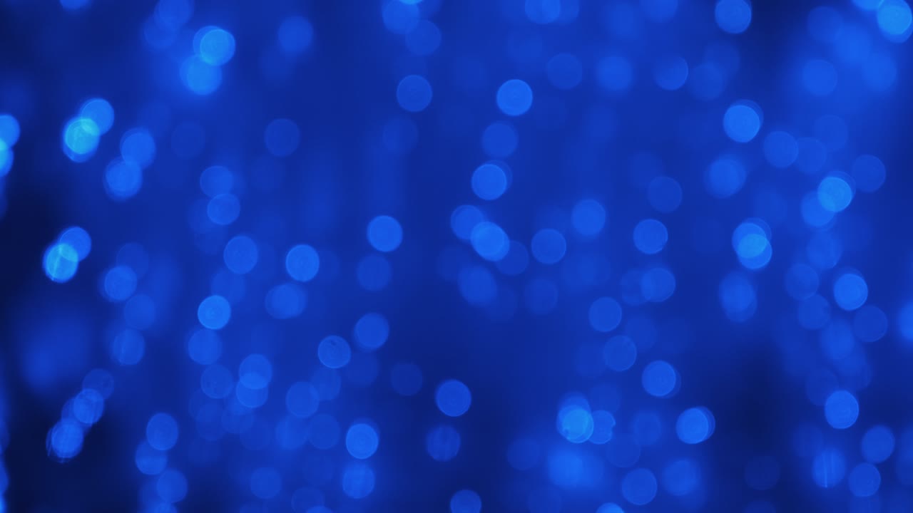 Panorama. Festive glowing background of moving blue lights. Defocused background. Blurred bokeh.