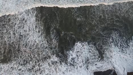 beautiful aerial over a black sand beach 4