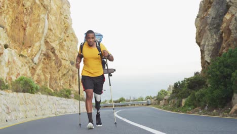 sporty mixed race man with prosthetic leg hiking