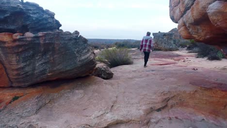 Man-walking-through-the-rock-formations-4k