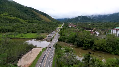 drone-shoot-of-a-Car-crossing-a-bridge-in-the-middle-of-the-rain-forest---Brazil