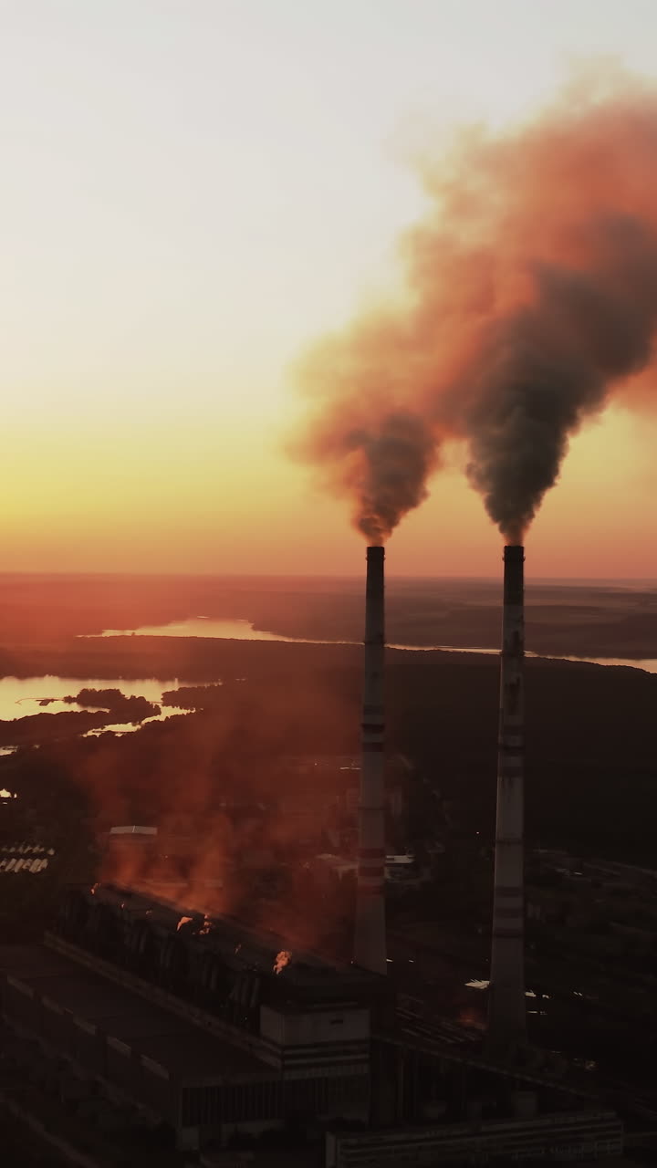 Static view of the power pylons on sunset time background. High voltage electric tower at the sunset. Fabric concept. Selective focus. Vertical video