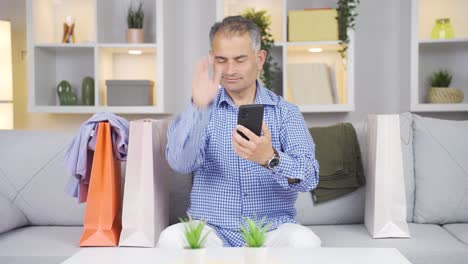 man looking at camera with shopping bags.