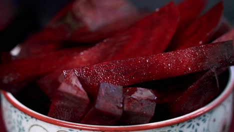 close up shot of beets being picked up from bowl to juice for a sweet vegan dessert chocolate muffin