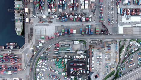 hong kong commercial port dock and holding platform with thous of shipping containers, aerial view