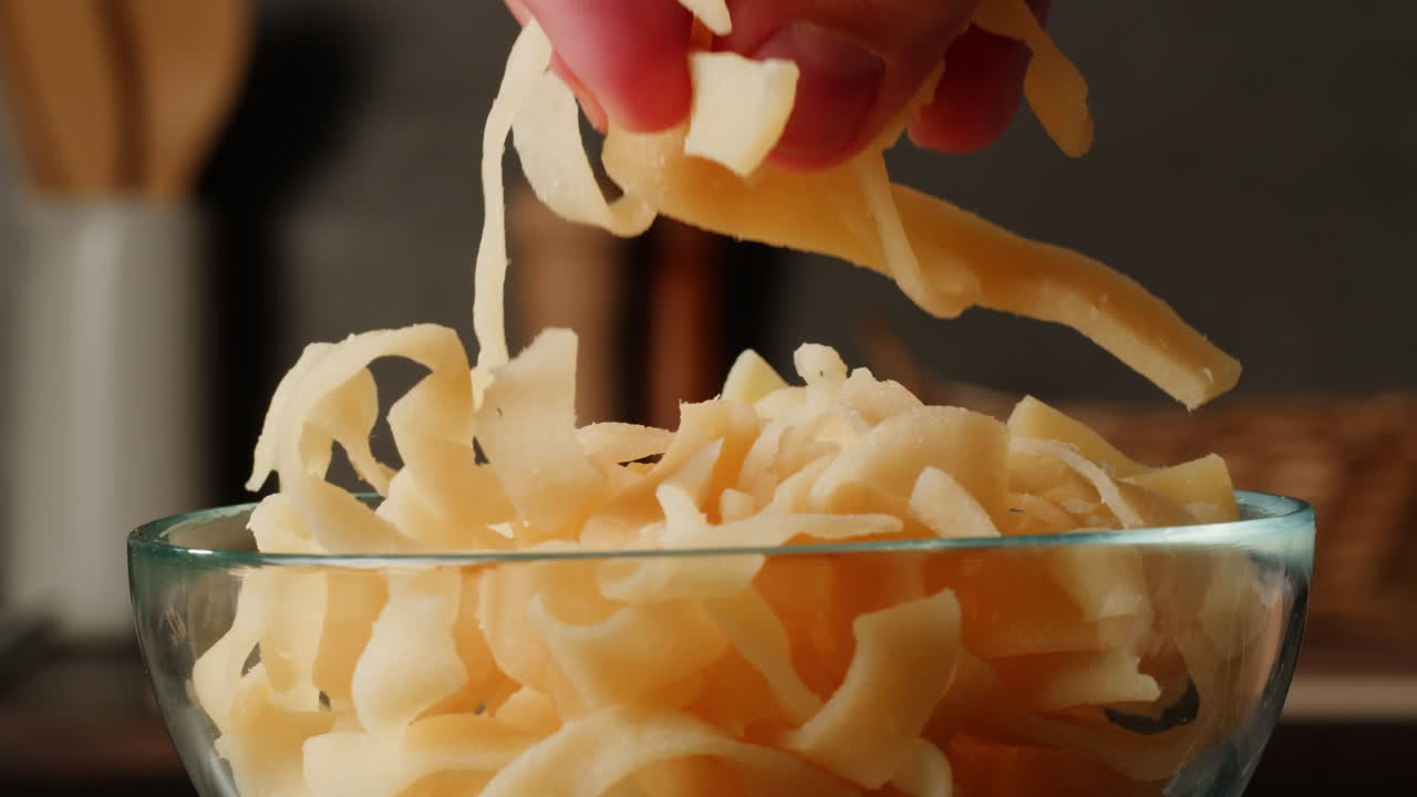 Hand picking dried vegetables from glass bowl