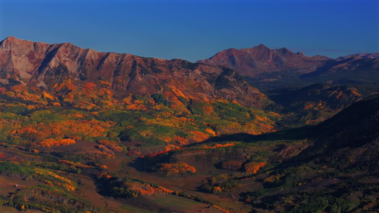 Scenic Fall autumn drive Kebler Pass Mill Creek farm land Ohio Creek Valley Pass Crested Butte Colorado Gunnison Country aerial drone Mill Castle rock landmark colorful Aspen trees pan right motion