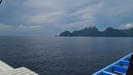 Traditional-Bangka-Filipino-Boat-Sailing-in-Sea-Water-Between-Islands-Near-El-Nido,-Palawan-on-Cloudy-Day-Passenger-POV