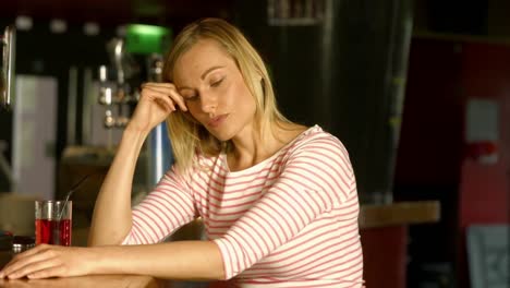 stressed woman sitting at bar