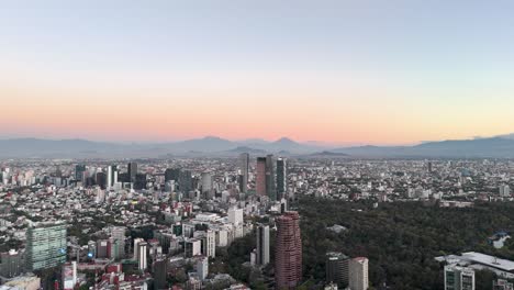 Drone-shot-of-skyscrapers-in-mexico-city-and-volcanoes