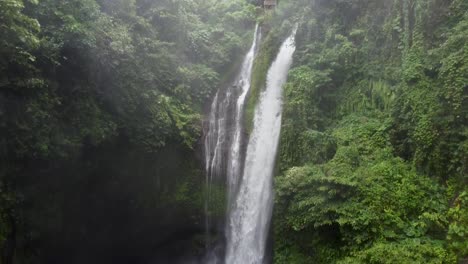 aerial descending shot of aling-aling waterfall in deep jungle of bali