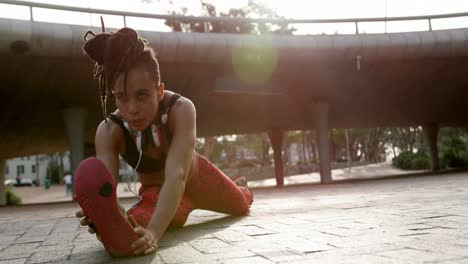 Front-view-of-young-African-American-woman-exercising-in-the-city-4k