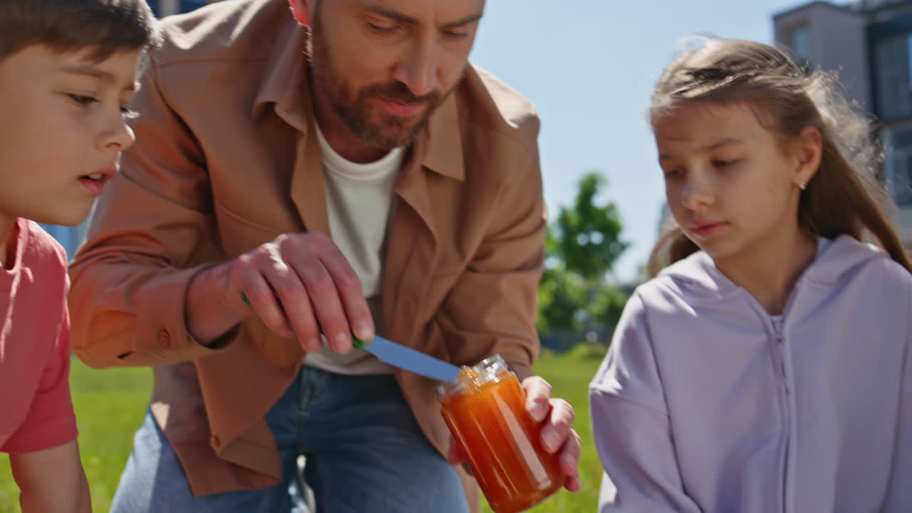 Father spending time children at picnic closeup. Cute kids looking at daddy