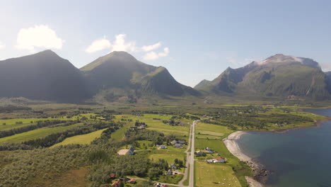 aerial shot of a mountain valley and farmland on the coast of norway