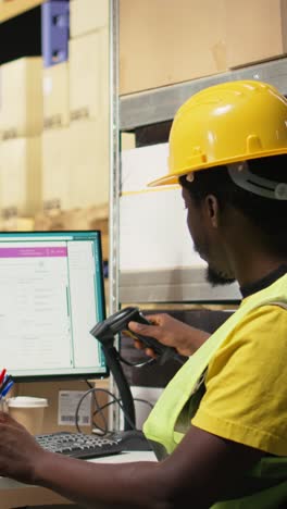 vertical video black staff member using a barcode scanner to process shipping labels