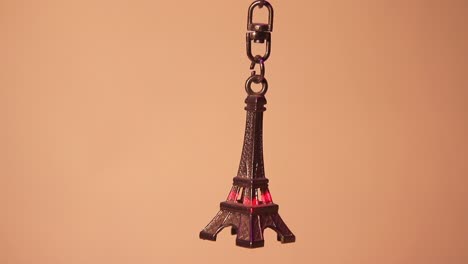 close up of the eiffel tower keychain and the horizontal laser light