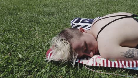 beautiful tourist woman relaxing while getting tan on a sunny day in toronto, canada - wide shot