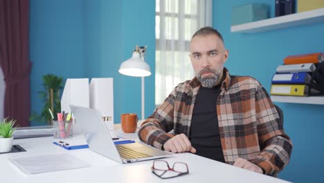 businessman looking at camera with a languid and serious facial expression.