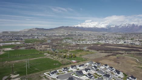 flying over scenic lehi city valley with snowy mountain background, utah