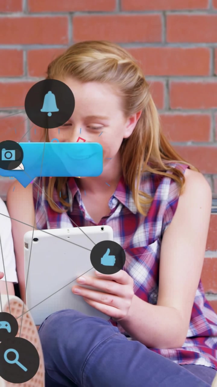 Vertical video: Student glancing at tablet causing icons linking to tablet tapping to share
