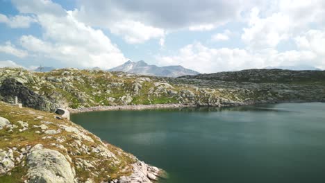 Aerial-view-of-Totensee-lake-and-dam-of-Grimsel-Pass-in-summer-season,-Switzerland