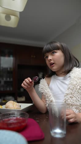 young girl eating dinner