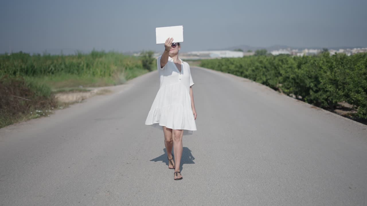 Woman taking a selfie on a country road