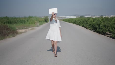 woman taking a selfie on a country road