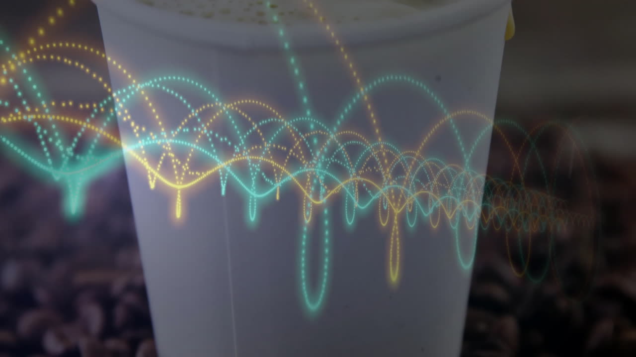 Coffee cup being animated in close-up showing foam top, roasted beans and teal yellow waveforms